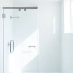 Showcasing glass shower doors with sleek design and reflective qualities in a modern bathroom